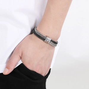 Detail of men's two-tone fish scale chain bracelet in black and silver stainless steel