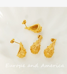 Detailed macro view of 18k gold plated hollow teardrop earrings with lava texture