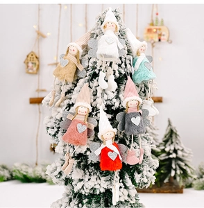 Close-up of plush angel ornaments in six colors hanging on a snow-covered Christmas tree