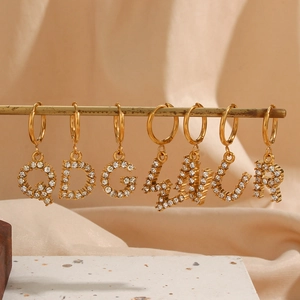 Detailed macro view of 18K gold plated alphabet earrings with micro-inlaid zircon crystals