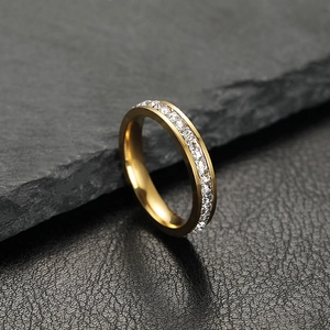 Elegant gold eternity ring with square cubic zirconia in a minimalist stainless steel band