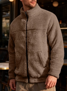 Detail shot of men's brown fleece jacket showing plush texture and high neck zipper closure