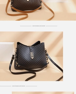 Close-up of printed bucket bags with textured cross patterns and golden metal hardware details