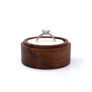Macro shot of a brilliant round cut ring in a premium wooden wedding jewelry box