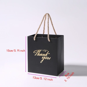 Detail of black gift bag with gold Thank You text showing dimensions 15x13x8 cm