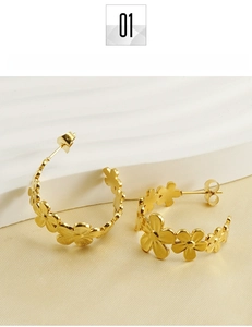 Macro shot of 18k gold plated titanium steel daisy flower hoop earrings on a white stand