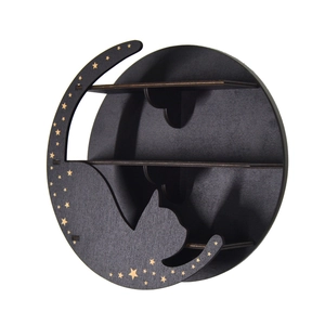 Detail view of black wooden crystal shelf with cat silhouette and golden moon stars