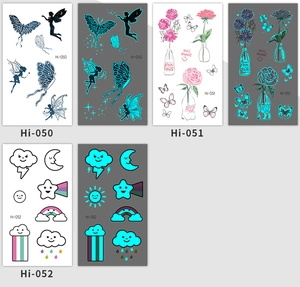 Luminous blue tattoo stickers showing butterfly and moon patterns in day and night views
