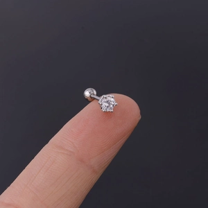 Detailed close-up of a 20G stainless steel cartilage stud with six-prong zircon setting
