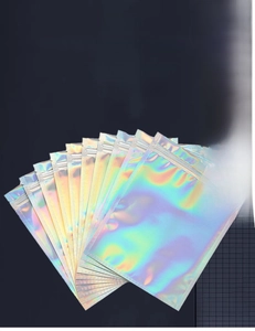 Detail of 100pcs holographic laser seal bags showing rainbow finish and zipper closure