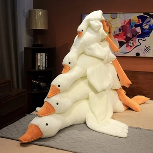 Soft cartoon big white goose plush toy covers stacked on bed in a home setting
