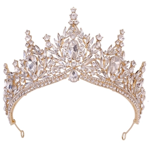 Detailed close-up of golden bridal crown with sparkling crystal leaves on white background