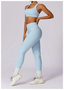 Detail of light blue high-waist yoga leggings and sports bra with seamless texture