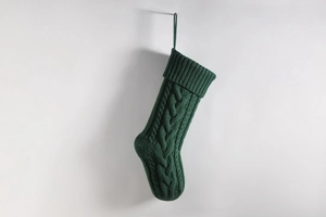 Detail of forest green cable knit Christmas stocking with classic textured pattern