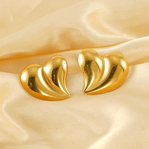 Polished 18K gold stainless steel liquid heart stud earrings on champagne silk background