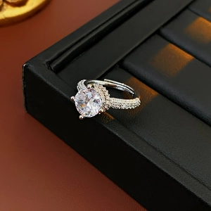 Macro view of silver adjustable ring with round cubic zirconia and pavé-set band stones