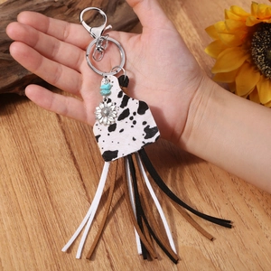 Western boho keychain with cow print cowhide, turquoise beads, and long suede tassels