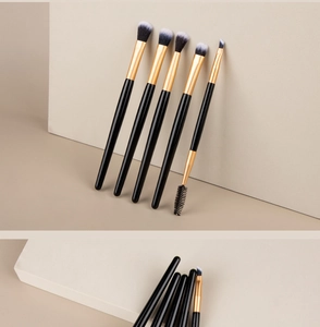 Detail of a 5-piece makeup brush set with gold ferrules and soft gradient bristles