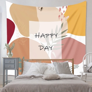 Detail of bohemian tapestry featuring abstract geometric patterns and Happy Day text print