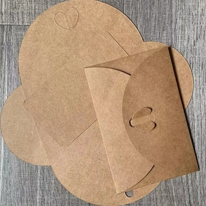 Detail view of brown kraft paper envelope with creative heart-shaped clasp design