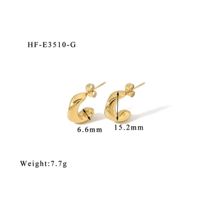 Detail view of 18K gold C-shape twisted earrings showing 15.2mm height and 6.6mm width