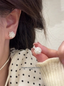 Close-up of elegant pearl cluster stud earrings with sterling silver needles for women