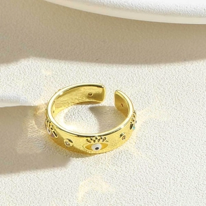 Detailed macro view of 14K gold plated eye motif ring with enamel and zircon inlay