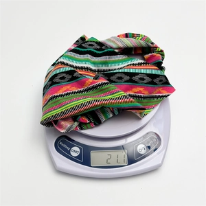 Ethnic multicolored knit headband with geometric patterns and stripes on a scale
