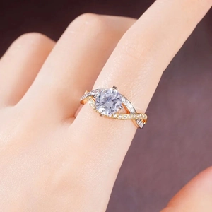 Detailed view of dual-tone twisted wedding ring with round zircon and micro-pave diamonds