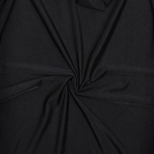 Detailed close-up of premium black knitted fabric showing fine texture and elasticity