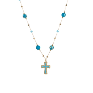 Detail of gold necklace with blue stone beads and a blue gemstone cross pendant