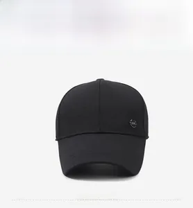 Close-up of a black baseball cap featuring a metal SPORT badge and reinforced stitching