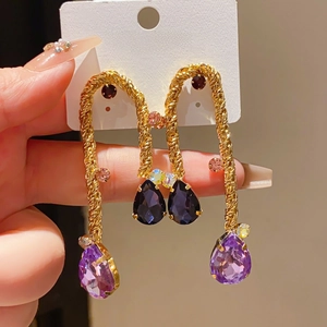 Detail of vintage gold drop earrings with purple and blue crystals and S925 silver needles