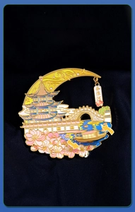Detail of Qinhuai River metal souvenir magnet with movable boat on dark velvet