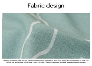 Macro detail of green fabric with white patterns and washing instructions on a garment