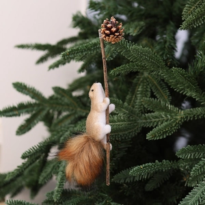 Christmas foam squirrel ornament with pine cone hanging on a green Xmas tree branch