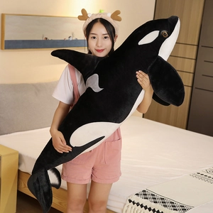 Giant lifelike orca plush body pillow made of soft black and white fabric for home decor
