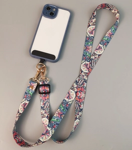 Detail view of colorful patterned phone strap with gold metal buckles and blue case