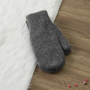 Winter dark grey rabbit fur knitted mittens with warm plush lining on a soft white background
