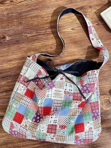 Vintage patchwork canvas tote bag with colorful floral patterns and drawstring closure