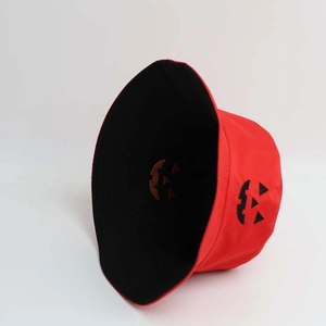 Detail of red Halloween bucket hat with black lining and pumpkin face embroidery