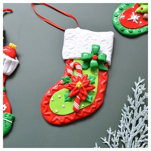 Macro detail of Christmas stocking ornament with candy cane and poinsettia motifs