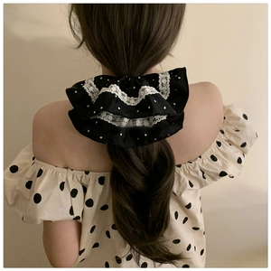 Polka dot satin scrunchie with lace trim shown on a ponytail for a vintage French look