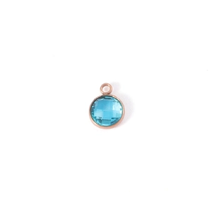 Detail of 7mm faceted blue birthstone pendant with rose gold bezel for DIY jewelry