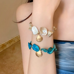 Handcrafted shell and bead bracelets set with golden sea pendants for beach vacation