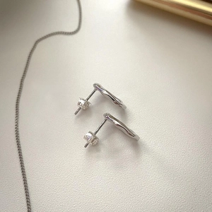 Minimalist irregular wavy sterling silver stud earrings with high-polished metal finish