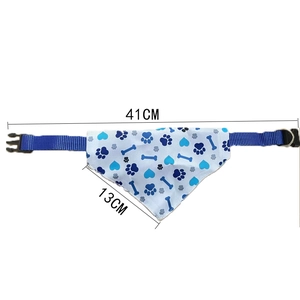 Detail of blue pet bandana showing 41cm length and 13cm height with paw print patterns