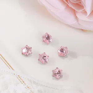 Macro detail of 7x7mm pink star-shaped faceted crystals for luxury nail art decoration