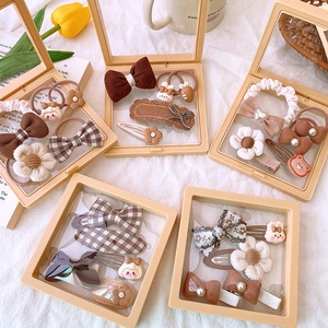 Detailed view of 5-piece fabric hair accessory gift sets in milk tea and brown tones
