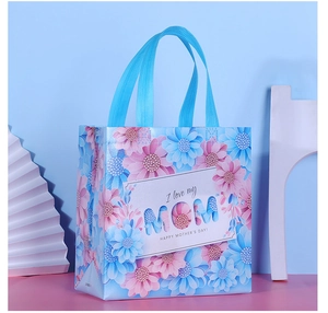 Detail of floral non-woven gift bag with Happy Mother's Day text and blue floral patterns